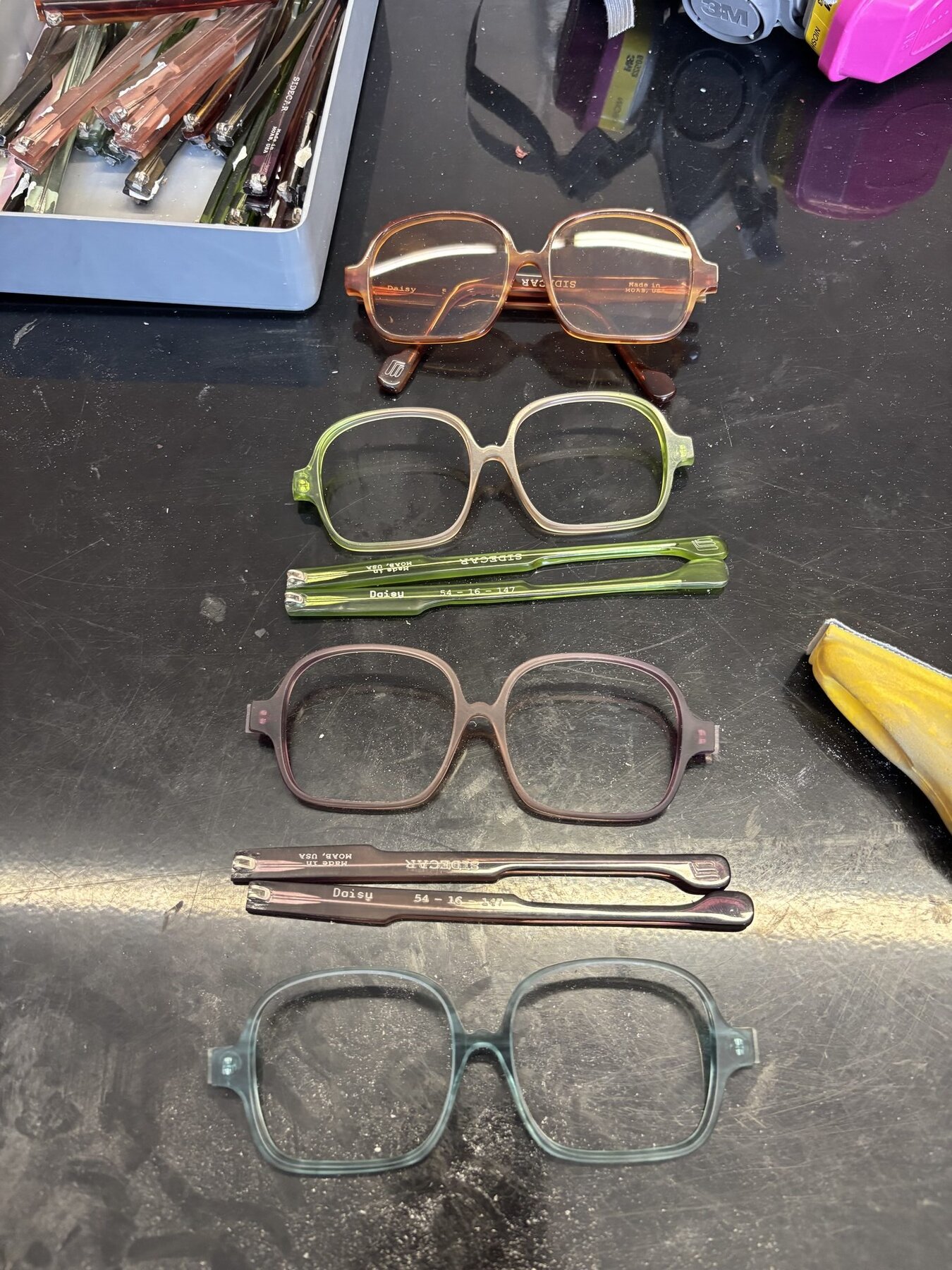Physical prototype frames in various colors on workbench