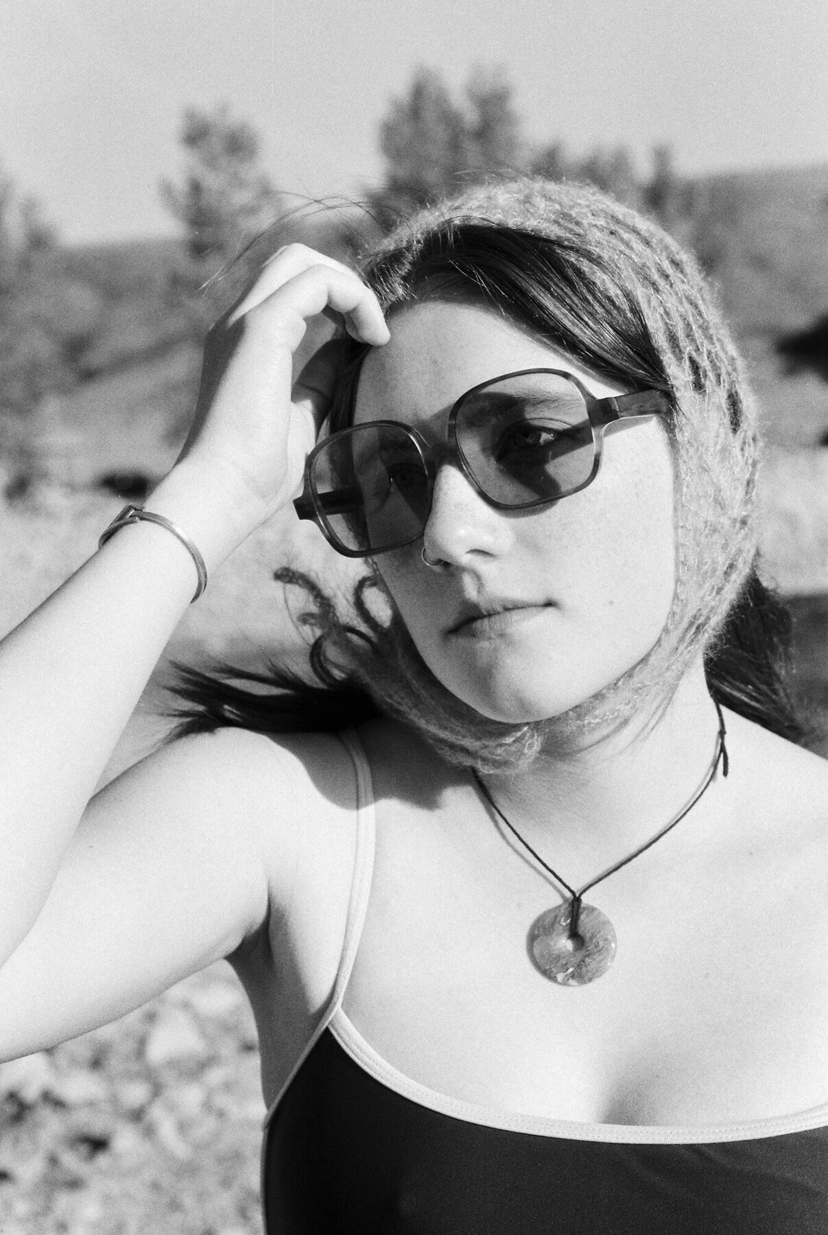 Portrait wearing finished sunglasses, black and white