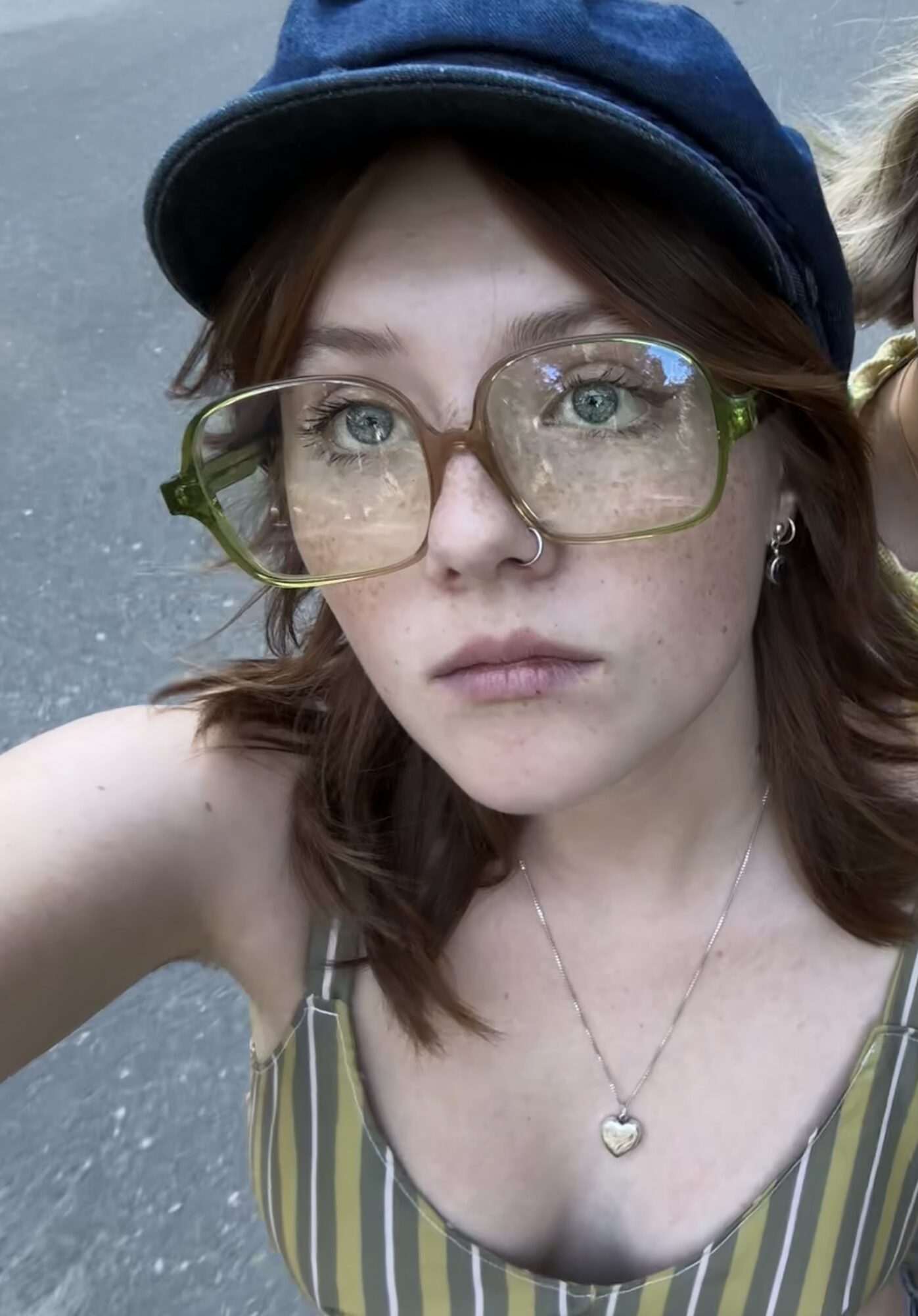 Portrait wearing finished sunglasses with blue cap