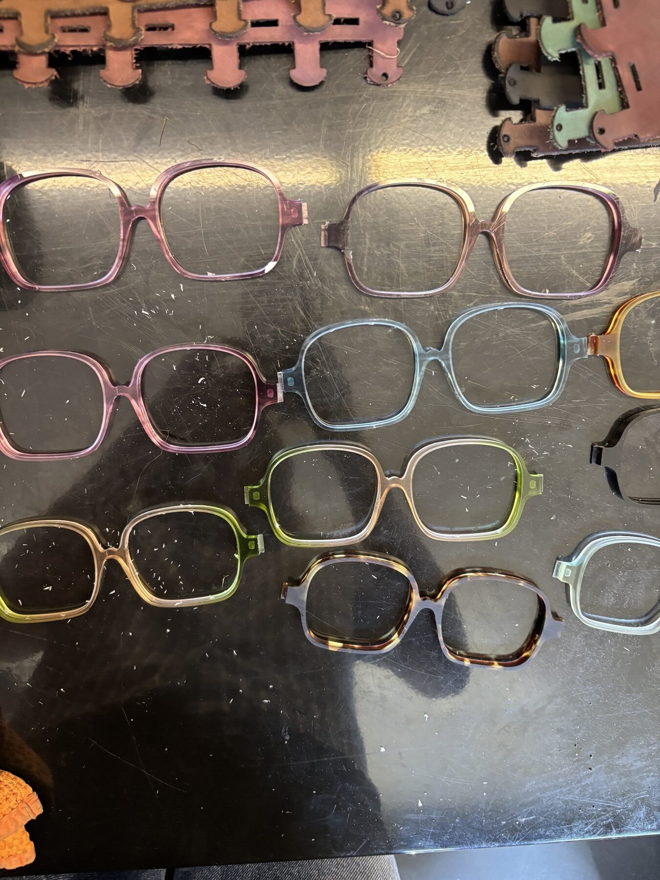 Cut acetate frames in various colors on work surface