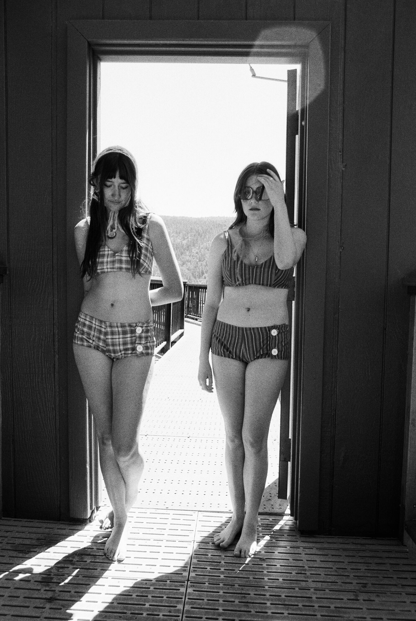 Two models in doorway wearing vintage-inspired swimwear