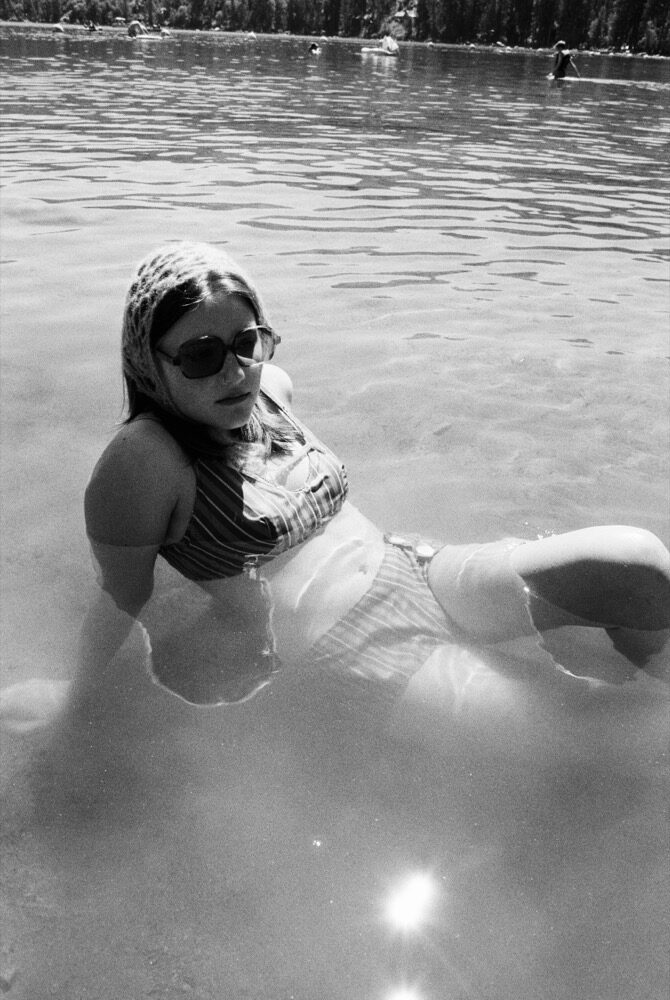 Model with sunglasses in the water